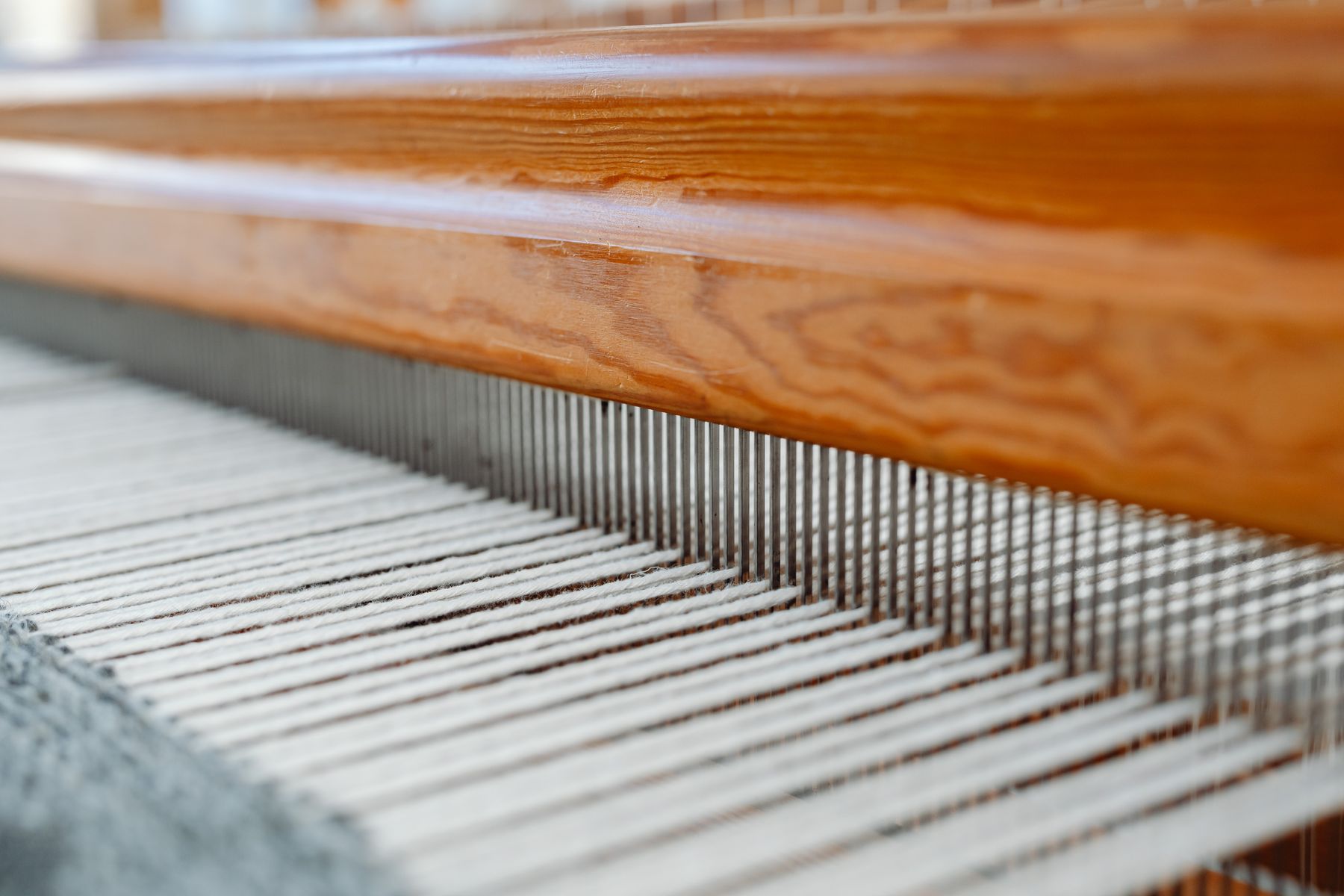 Close-up view of threads aligned on a weaving loom